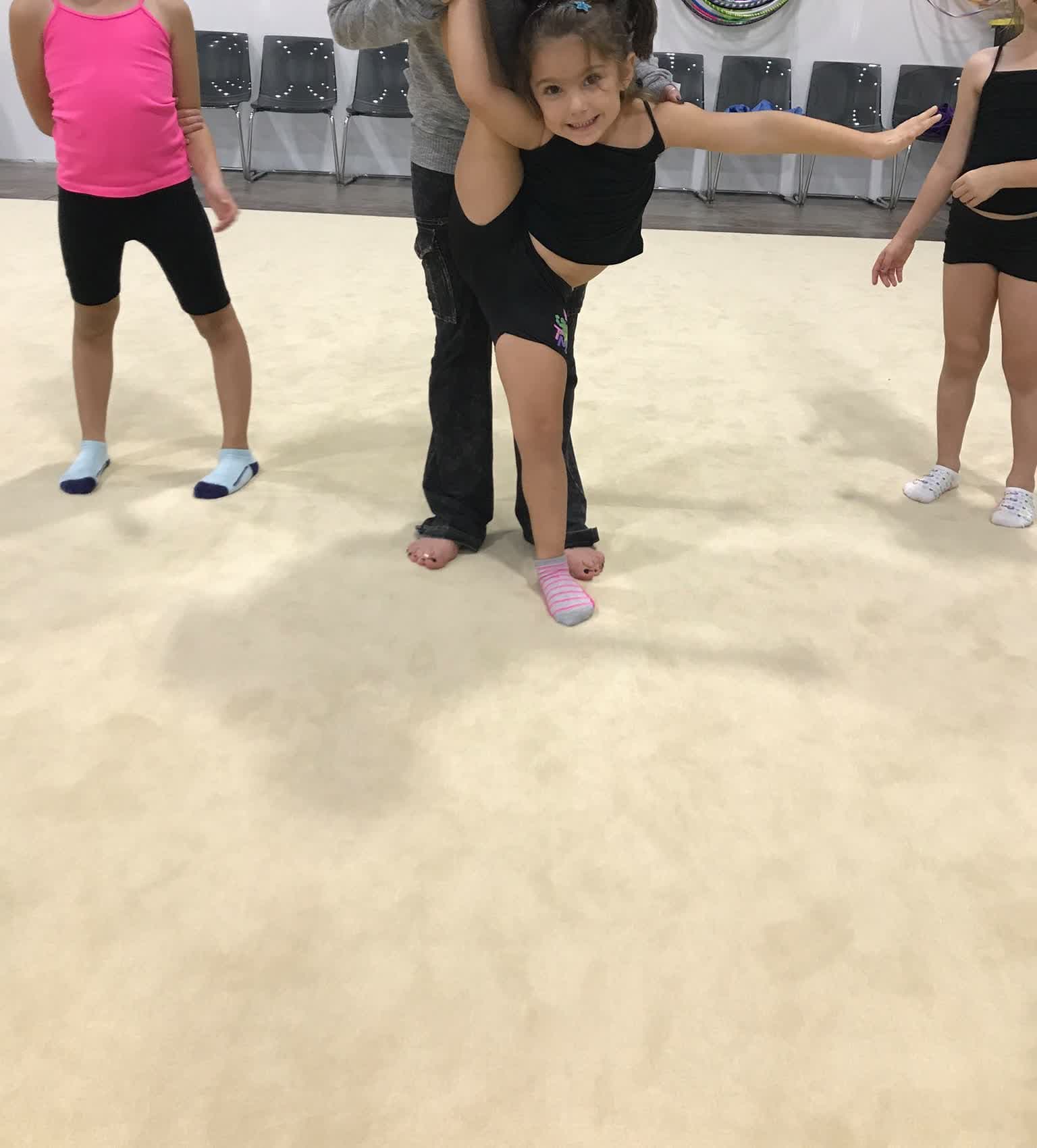Coach helping student with backbend