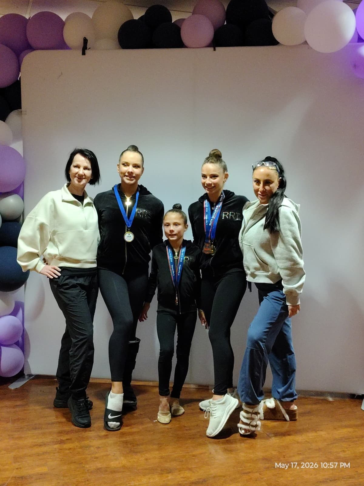 RRT coaches and athletes celebrating together at the 2026 USAG Rhythmic Elite Qualifier