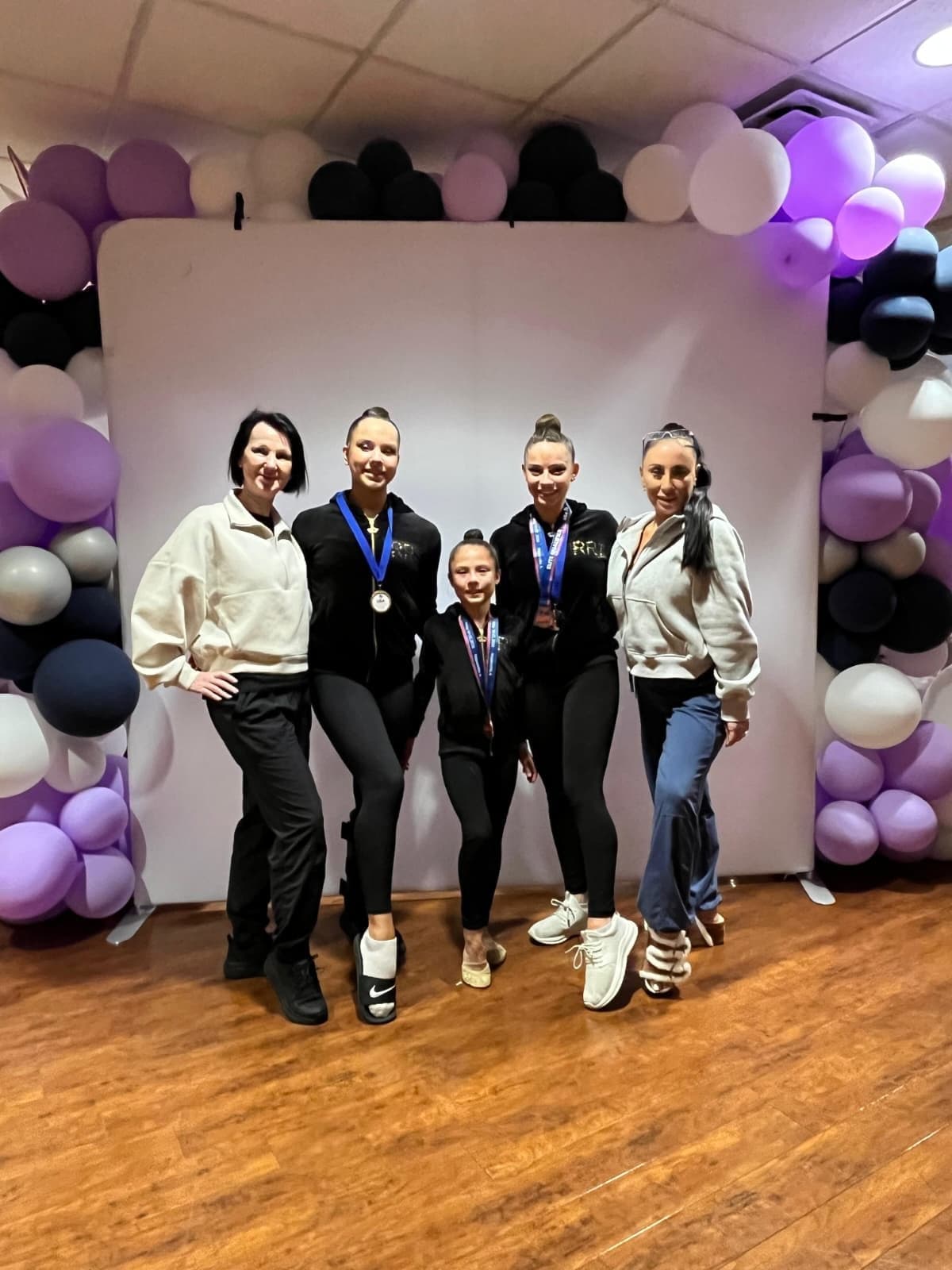 RRT coaches with athletes after medaling at the 2026 USAG Rhythmic Elite Qualifier
