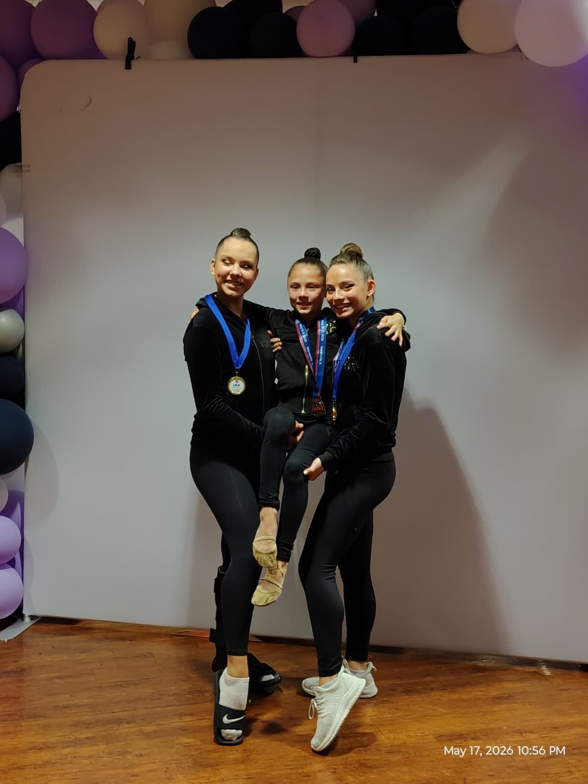 RRT teammates celebrating with medals at the 2026 USAG Rhythmic Elite Qualifier