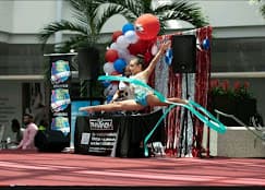 Gymnast leaping with ribbon at competition