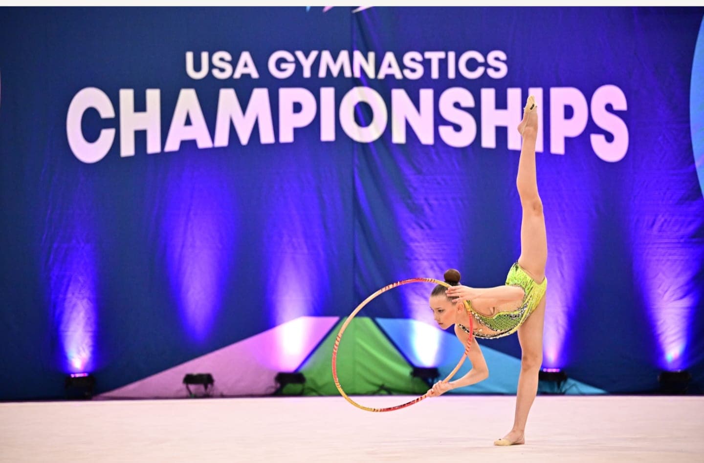 Gymnast performing penche with hoop at USA Gymnastics Championships