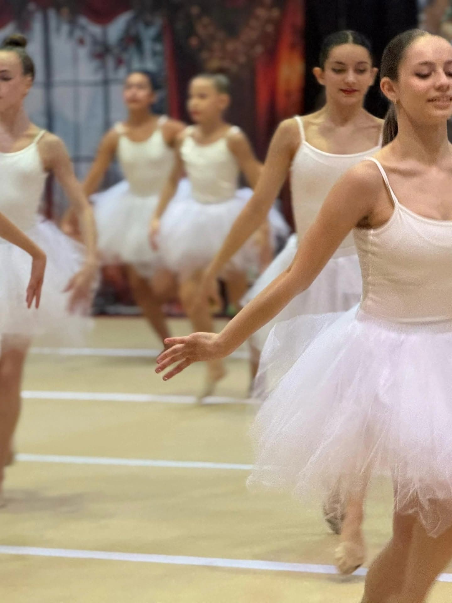 Ballet number in white leotards and tutus at a holiday showcase