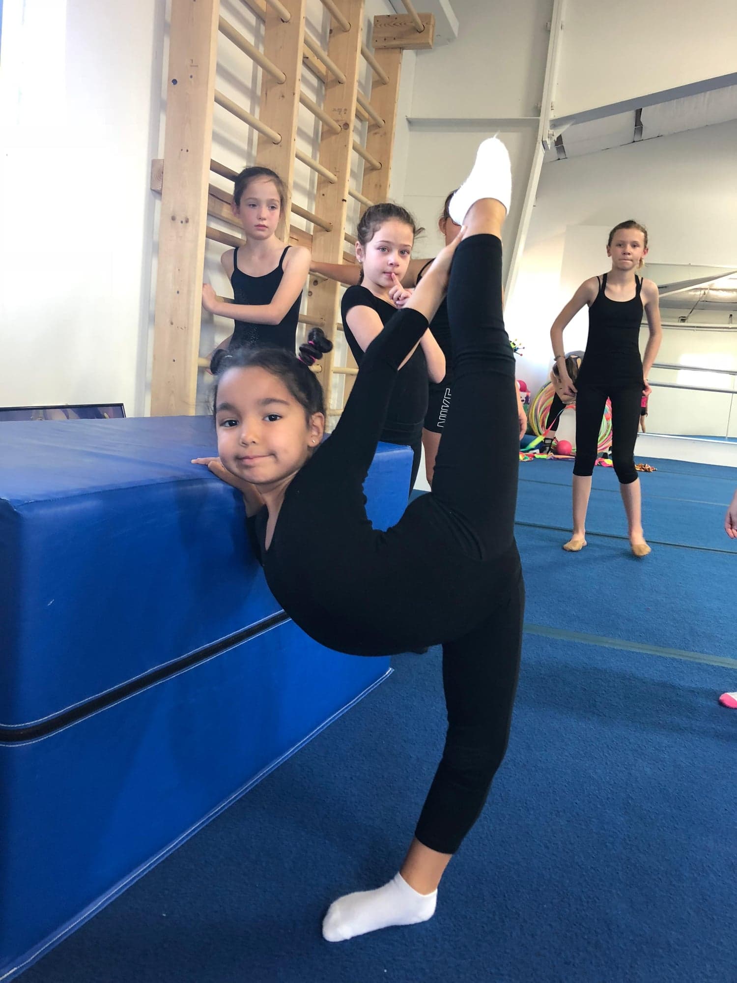 Student performing standing split in class