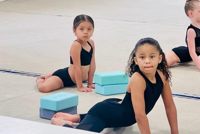 Young students practicing splits