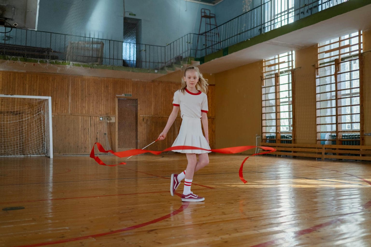 Young girl focused on her ribbon during a rhythmic gymnastics routine
