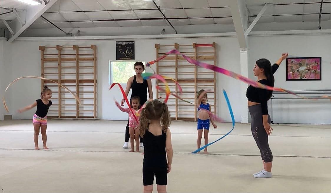 Young RRT preschool students practicing ribbon skills with their coaches